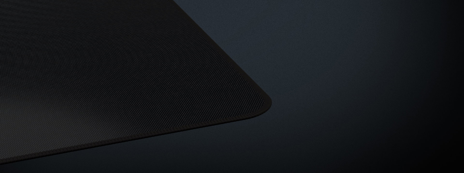Black gaming mouse pad with a textured surface and rounded edges, measuring 1100x450mm