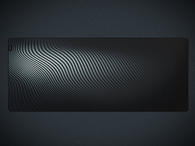 Black gaming mouse pad with a textured surface, featuring a wave design, measuring 1100x450mm