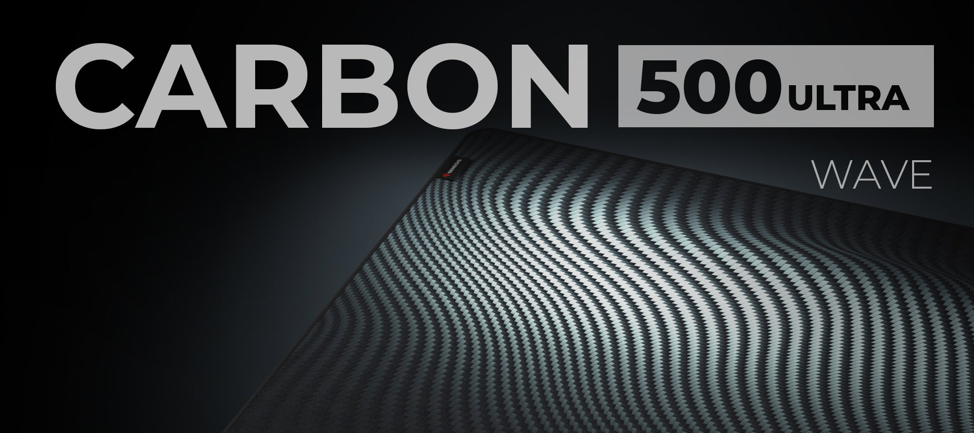 Large mouse pad with a wave pattern, featuring "CARBON 500 ULTRA WAVE" text, measuring 1100x450mm