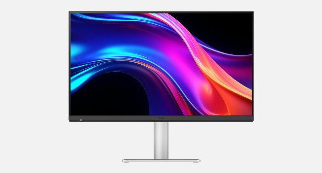 Moderne computermonitor of display met slanke witte standaard, die levendige blauwe en roze abstracte golfpatronen toont tegen een donkere achtergrond.