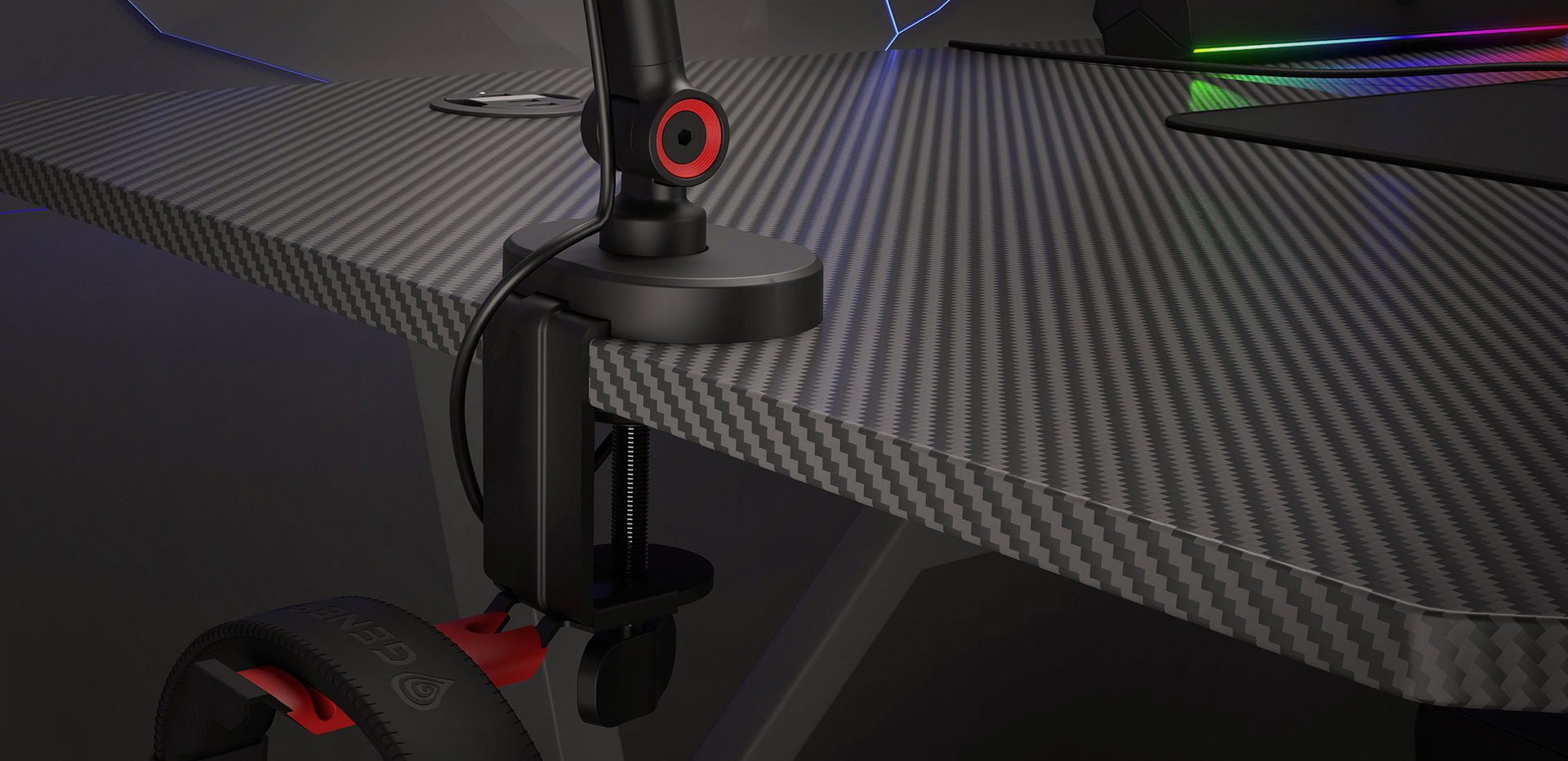 Microphone arm attached to a gaming desk with a headset holder, featuring a sleek black design and red accents