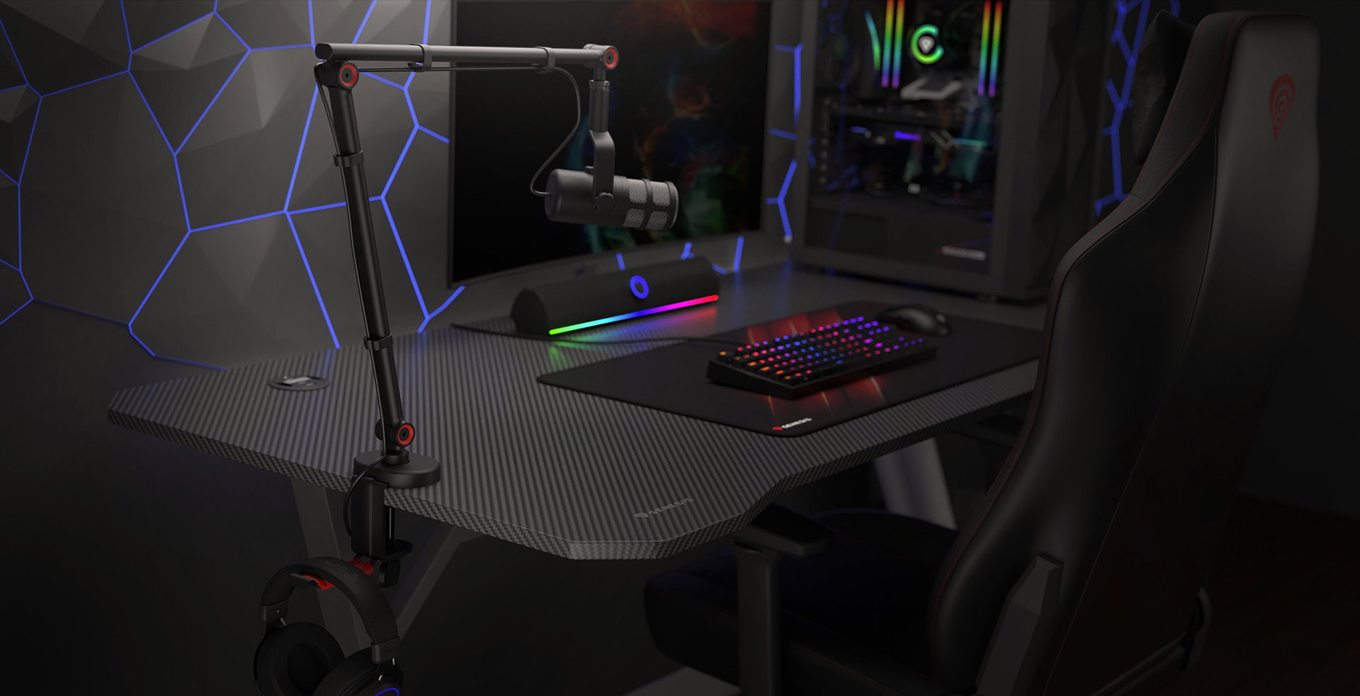 Microphone arm with a headset holder, positioned on a sleek gaming desk featuring a keyboard and colorful lighting