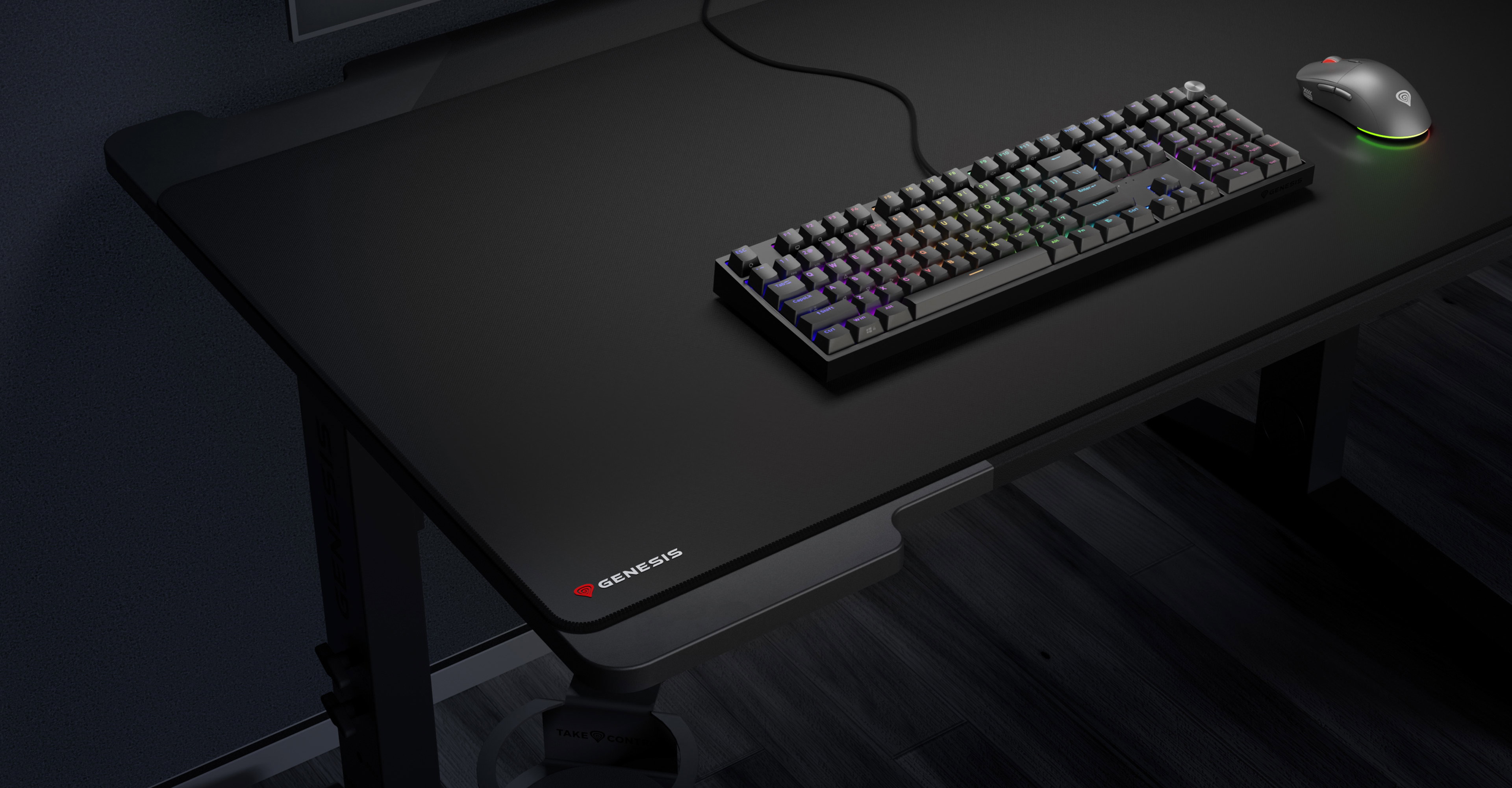 Large black mouse pad on a desk with a keyboard and a mouse