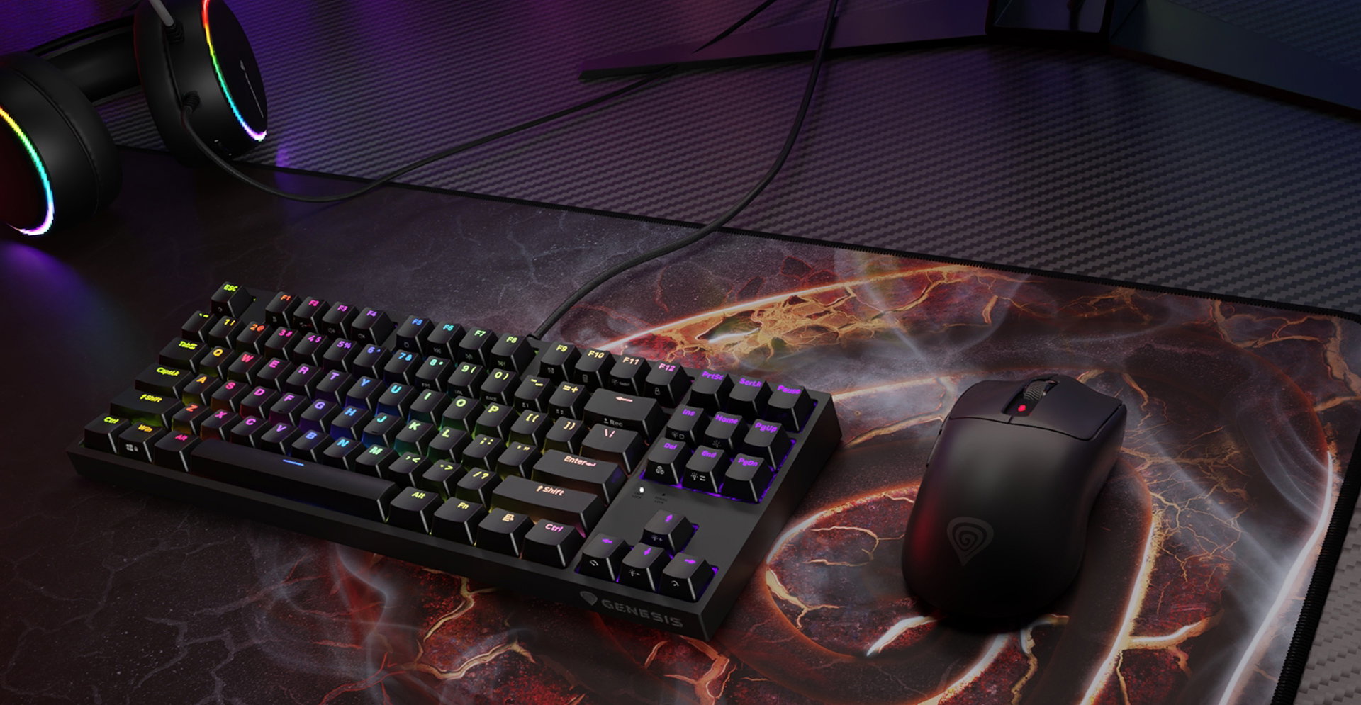 A gaming keyboard with colorful backlighting and a computer mouse on a decorative mouse pad.