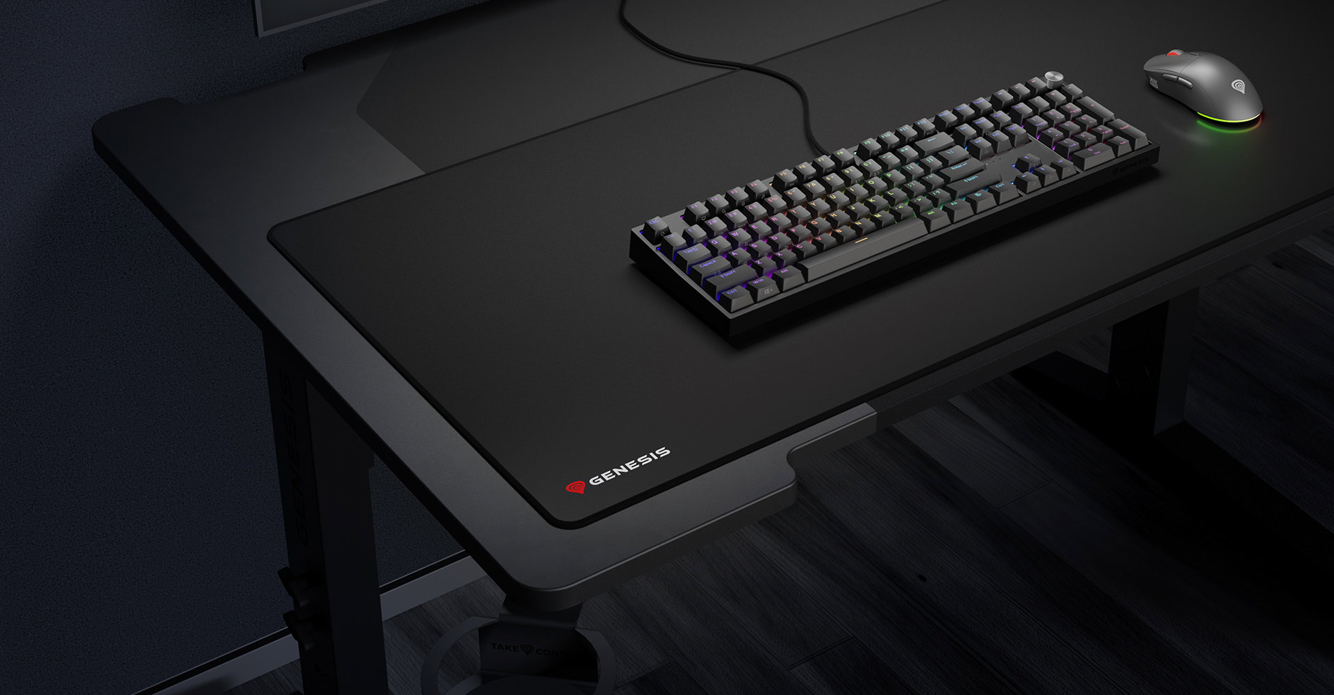 Large black mouse pad with a logo, keyboard, and a mouse on a dark desk